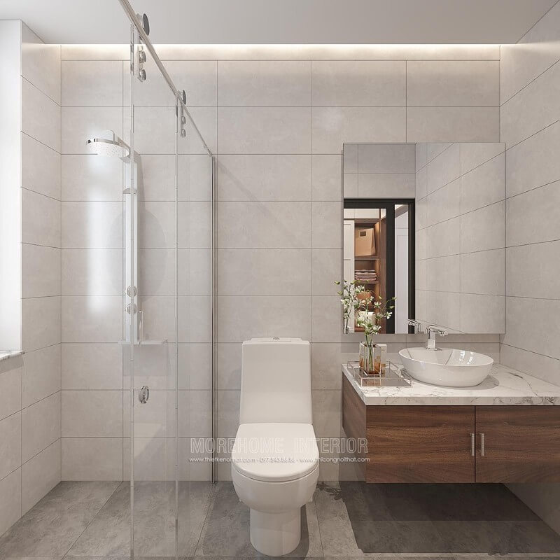 Thiết kế phòng tắm chung cư theo phong cách hiện đại đẹp với cách lựa chọn đồ vật tinh gọn nhưng lại tạo vẻ đẹp sang trọng cuốn hút từ tường ốp gạch giả bê tông, gương hình chữ nhật không khung ốp tường, phòng tắm kính cửa trượt. Mẫu thiết kế nội thất chung cư đẹp